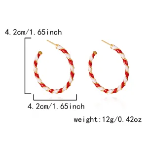 Red and white twisted enamel Christmas hoop earrings with 4.2cm diameter and 12g weight