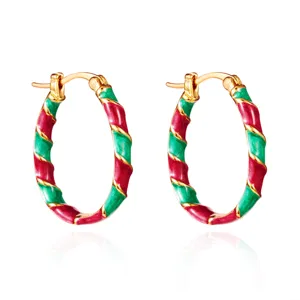 Detailed view of Christmas red and green twisted enamel hoop earrings in gold finish