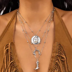 Detailed view of triple layered Western cowboy necklace with hat and boot pendants