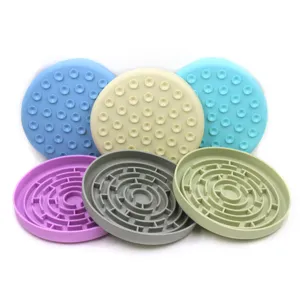 Detailed view of colorful silicone pet slow feeder mats with suction cups and maze patterns