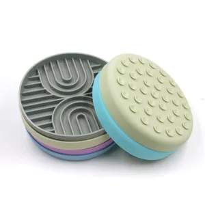 Round silicone pet lick mat with suction cups and slow feeder texture in multiple colors