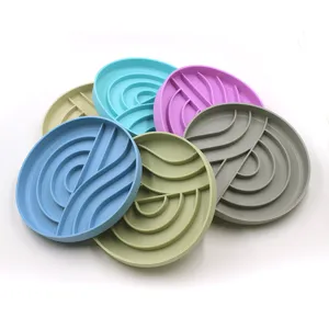 Overhead detail of colorful silicone pet slow feeder mats with wave patterns.