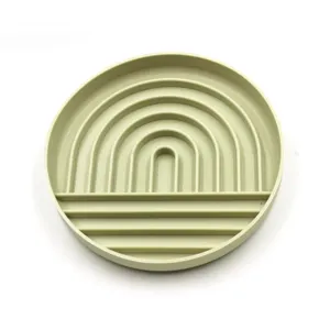 Silicone pet slow feeder bowl in green, anti-choking design with rainbow interior grooves.