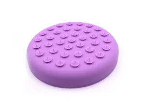 Detailed view of purple silicone pet lick mat with suction cups for slow feeding.