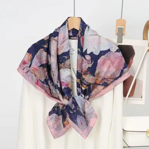 Detailed view of luxury silk wool square scarf featuring elegant floral print and pink border.