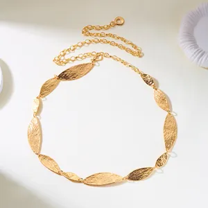 Vintage gold waist chain featuring textured hammered leaf-shaped metallic plates