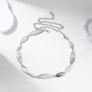 Detailed close-up view of a vintage silver hammered leaf metal waist chain accessory.