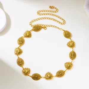 Close-up of vintage gold waist chain with intricate heart and oval carved pendants