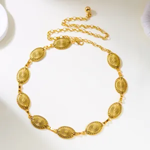 Close-up of elegant gold metal waist chain featuring vintage sunburst carved oval plates