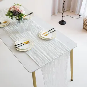 Detailed view of white gauze cheesecloth table runner, perfect for wedding party decor.