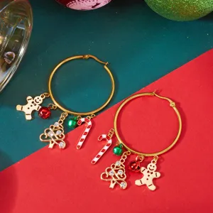 Close-up of festive Christmas hoop earrings with gingerbread man and candy cane charms