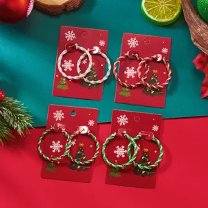 Set of Christmas-themed twisted hoop earrings in festive red, green, and silver colors.