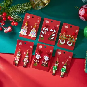 Detailed view of various colorful acrylic Christmas earrings on festive red cardstock
