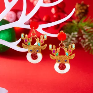 Festive close-up of golden glitter reindeer acrylic earrings hanging on a white branch