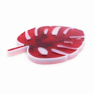 Detailed close-up of a monstera leaf red resin mold coaster, showing marbled texture.