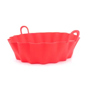 Close-up detail of the red silicone air fryer pot featuring a fluted edge and dual side handles.