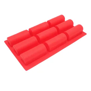 Detailed view of the red 9-cavity silicone baking mold, showing texture and cavity shape.