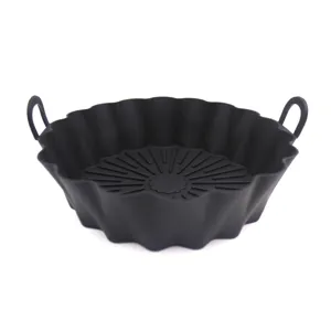 Silicone air fryer pot close up, black baking basket with handles, kitchen accessory detail.