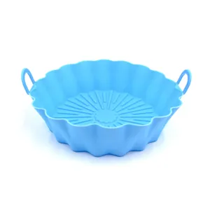 Blue silicone air fryer pot detail shot, showing textured bottom and double handles.
