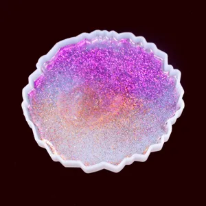 DIY irregular silicone coaster mold with sparkling purple pink glitter epoxy resin design.