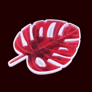 Detailed close-up of the translucent red monstera leaf silicone mold resin coaster feature.