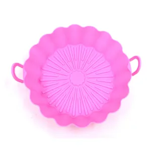 Pink silicone air fryer pot liner detail view featuring convenient handles and bottom ribs.