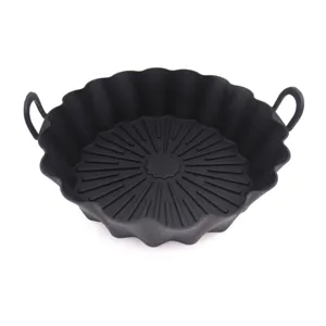 Black silicone air fryer pot detail showing fluted design and dual handles for baking food.
