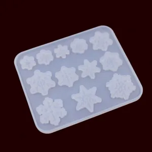 Silicone mold detail showing translucent snowflake cavities for DIY resin crafts and pendants.