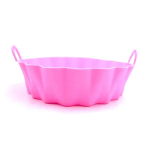 Pink silicone air fryer pot detail shot, flexible and heat resistant baking pad.