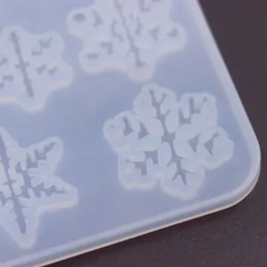 Closeup detail of snowflake silicone mold for resin casting, transparent craft DIY tool.