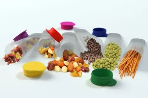 Detailed view of clear silicone ice pop mold tubes with colorful oval lids showcasing snacks inside.