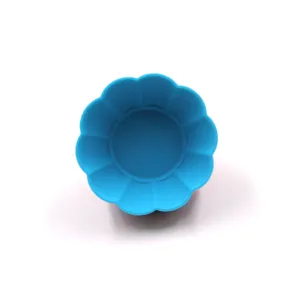Blue silicone baking cup detail view, flower shaped muffin mold for kitchen baking use.