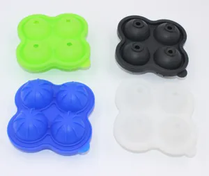 Detailed view of four colorful 4-cavity silicone sphere ice molds for chilling drinks.