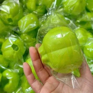 Green silicone garlic peeler detail view, flexible kitchen tool close-up showing texture.