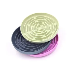 Macro view of three colorful silicone pet slow feeder mats stacked in green, grey and pink