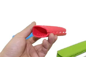 Silicone pot handle cover close-up, red heat resistant sleeve with anti-slip texture details.