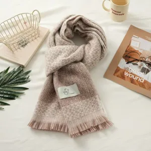 Detailed view of the cozy knitted plaid scarf featuring soft fringe and textured check pattern.
