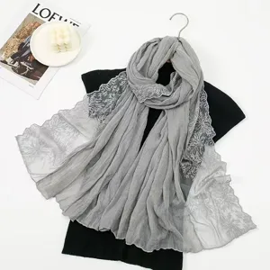 Grey cotton linen scarf detail showing delicate lace embroidery and soft pleated texture design.