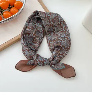 Detailed close-up view of the brown cotton blend small square scarf featuring elegant blue leaf pattern.