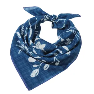 Detail shot of the blue cotton linen square scarf featuring white botanical prints and patterns.