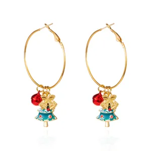 Detail view of festive hoop earrings with Christmas tree and bell charms
