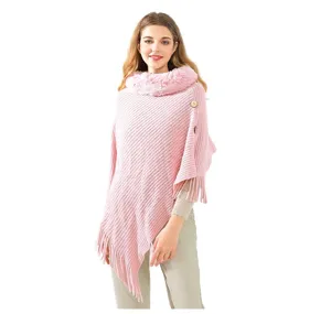 Elegant pink knitted poncho featuring a soft faux fur collar and stylish fringe hem