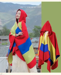Detailed view of women's ethnic style hooded poncho with vibrant tricolor stripes