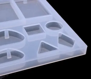 Translucent silicone mold for DIY epoxy resin jewelry pendants with various geometric shapes.