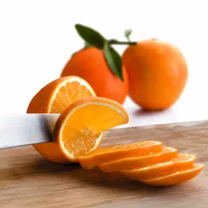 Primer plano de rodajas de naranja fresca en tabla de madera para repostería
