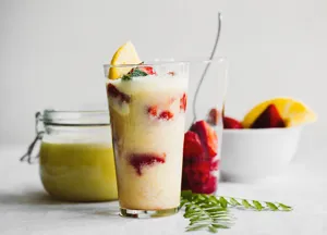 Köstlicher, frischer Frucht-Smoothie mit Erdbeeren und Orangen in einem hohen Glas