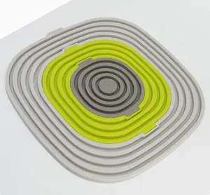 Alfombrilla aislante de silicona plegable, diseño encajable anti-quemaduras para cocina.