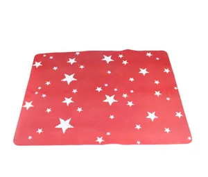 Red silicone kneading mat detail, showing food-grade material texture and white star pattern.