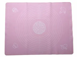 Detail view of the pink silicone baking mat featuring clear measurement scales and round size guides.