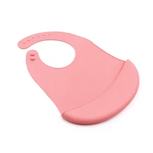 Waterproof silicone baby bib with crumb catcher pocket, soft infant feeding bib in pink.